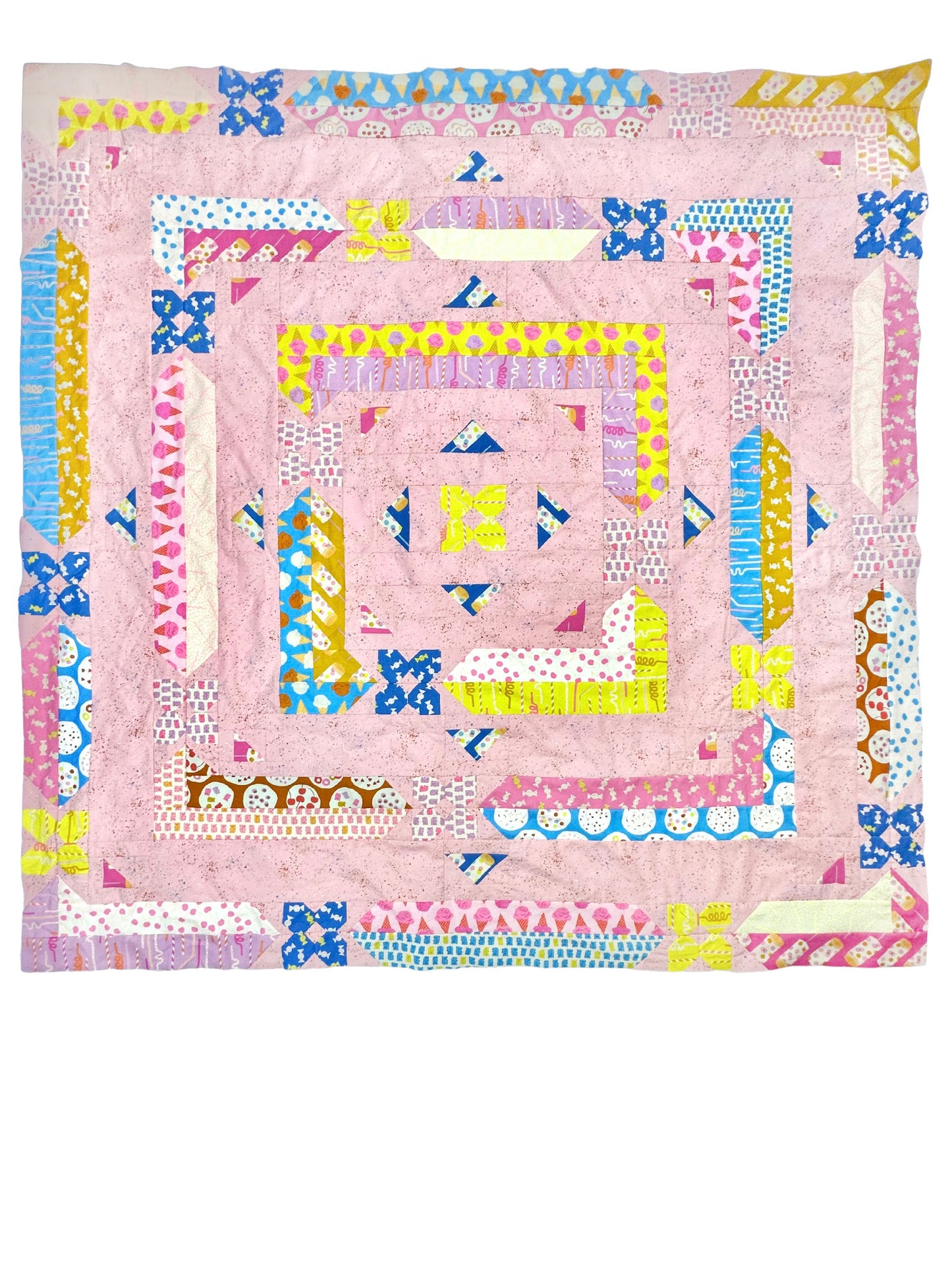 Albion Blooms quilt. A geometric quilt with small flower motifs surrounded by repeating medallion strips and triangles. Made in purple, pink, yellow, blue, and brown fabrics on a light pink background. Displayed flat on a white surface.