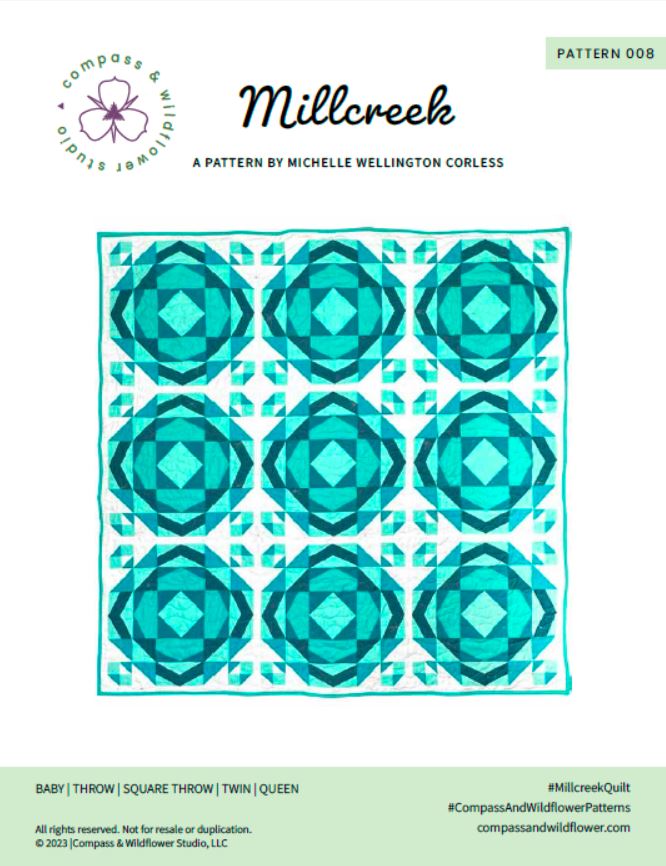 Millcreek Quilt pattern cover. A geometric quilt with a repeating motif that mimics water ripples. Made in varied shades of teal blue with a white background. Displayed outdoors in a snowy mountainous landscape. Pattern name and company logo.